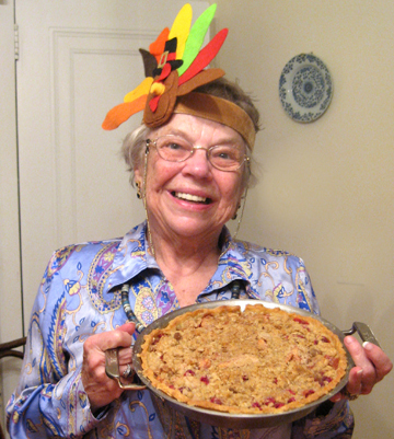 Aunt Lura (in seasonal headband) poses with the cranberry apple pie.