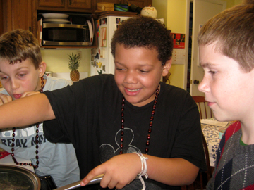 From left to right: Jackson, Michael, and Benjamin at the stove