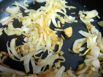 Mustard is added to caramelizing onions.